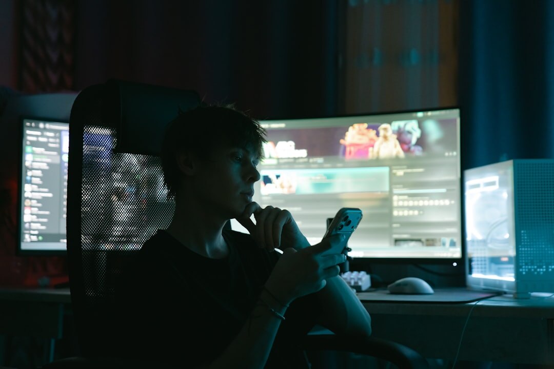 Cybersecurity professional monitoring screens in dark room
