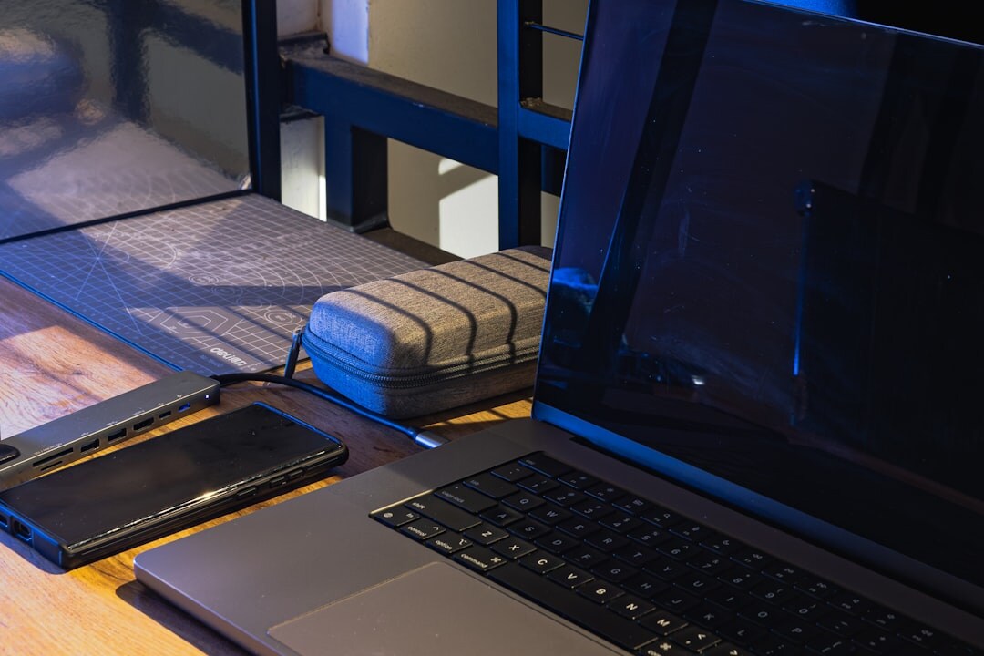 Open laptop on wooden desk with code on screen